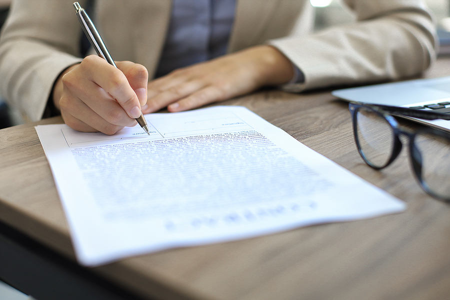 Two professionals finalizing a confidentiality agreement, ensuring the secure exchange of proprietary business information.