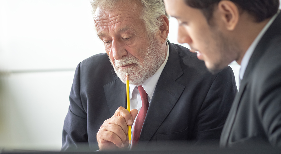 Business professionals collaborating on strategies to achieve high buyer success rates, showcasing Meritus Group's expertise in guiding buyers to successful acquisitions.
